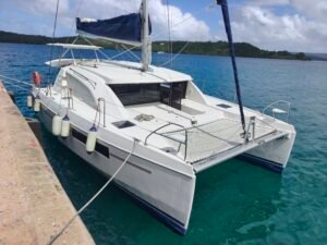 Leopard 40 with white fenders and blue sky tied to a concrete wharf during a yacht delivery. the picture is taken from the wharf